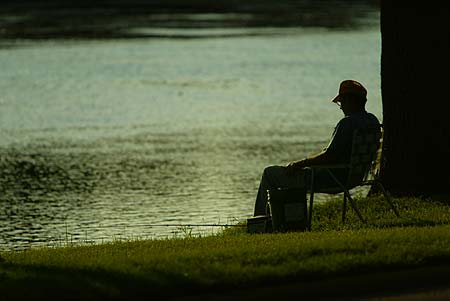 Person Sitting in Front of River